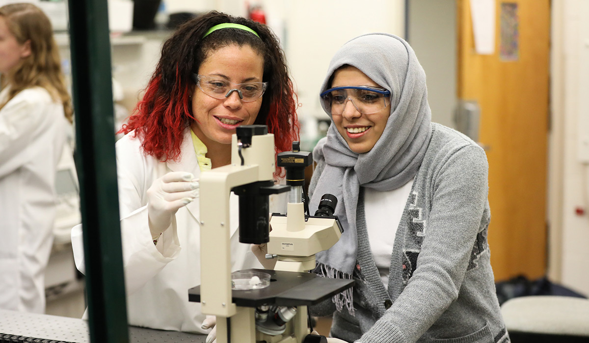 Students using a microscope in an engineering lab